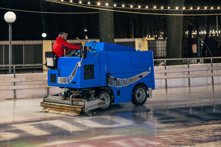 stadium-worker-cleans-ice-rink-blue-modern-ice-cleaning-machine